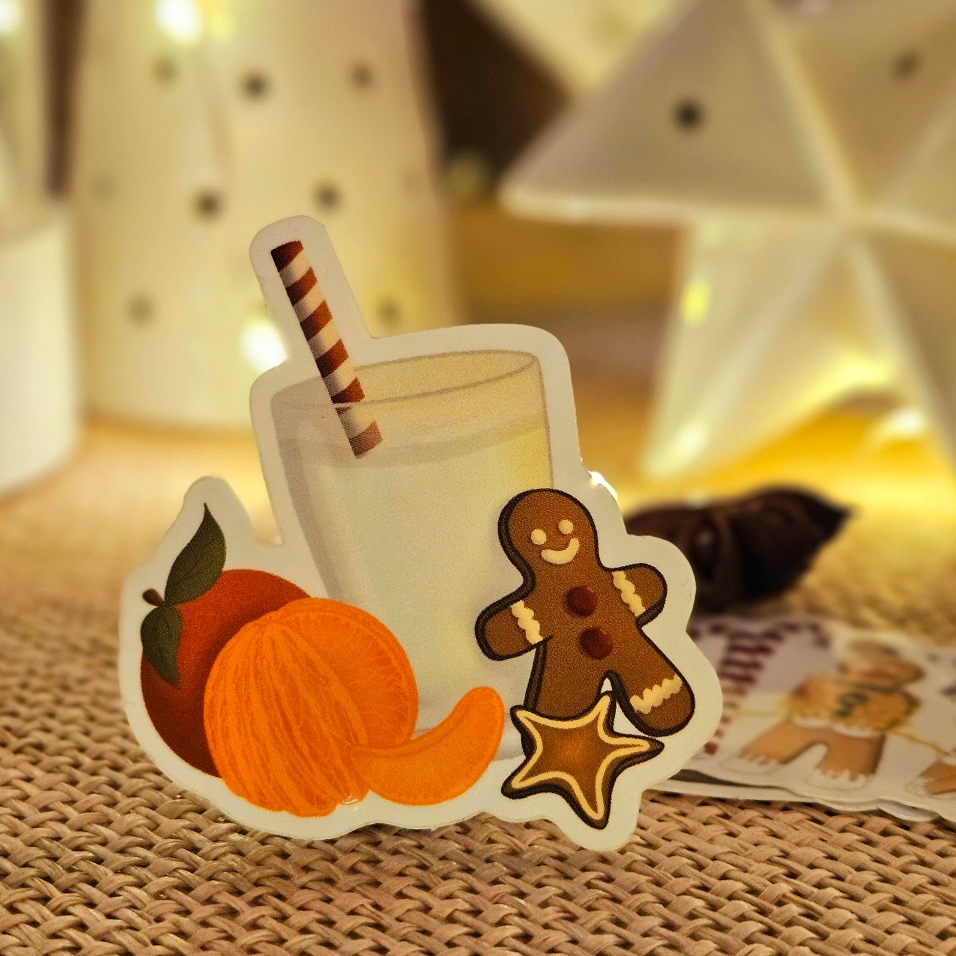 Sticke représentant le goûter de Noël parfait, des clémentines, des petits biscuits et un verre de lait